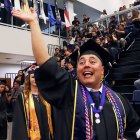 Newly-minted graduate Pete Howell waves to friends before the start of Thursday's graduation ceremony at West Hills College Lemoore.